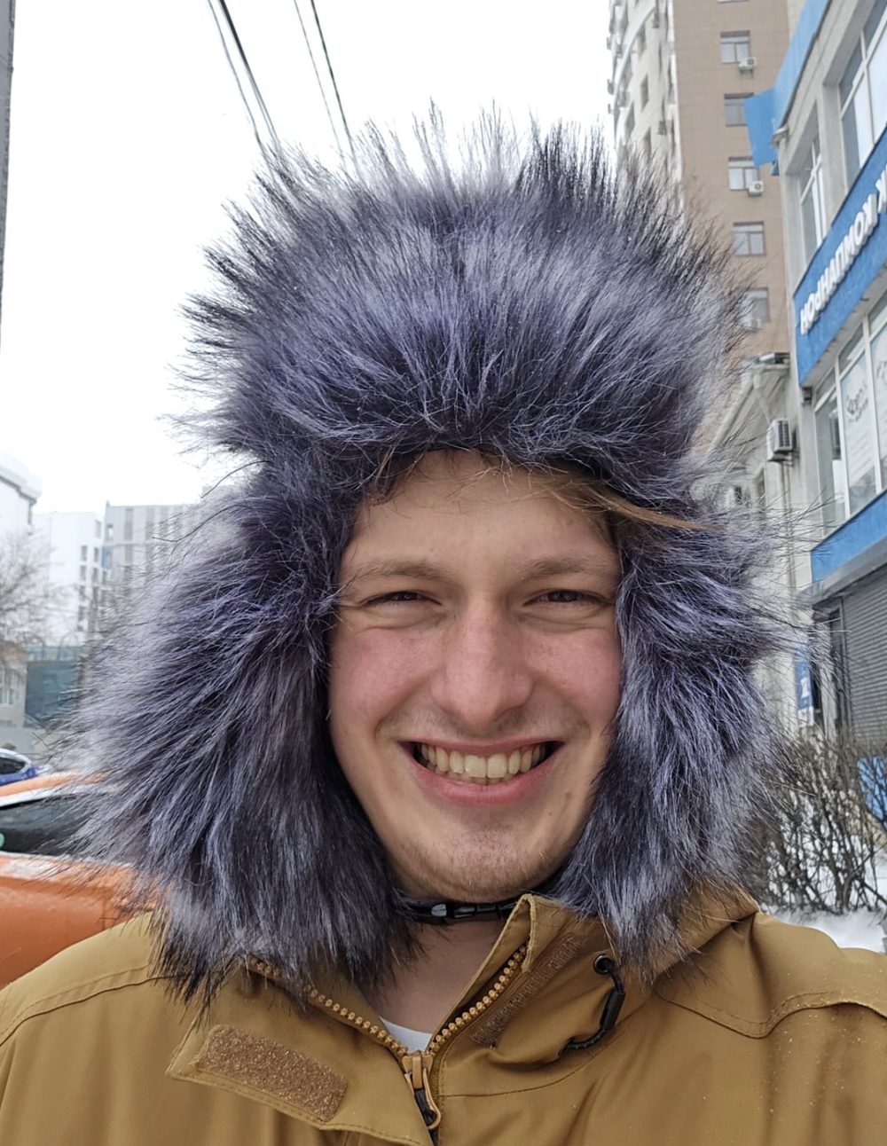 Viktor in a fur hat on a snowy street in Kyrgyzstan